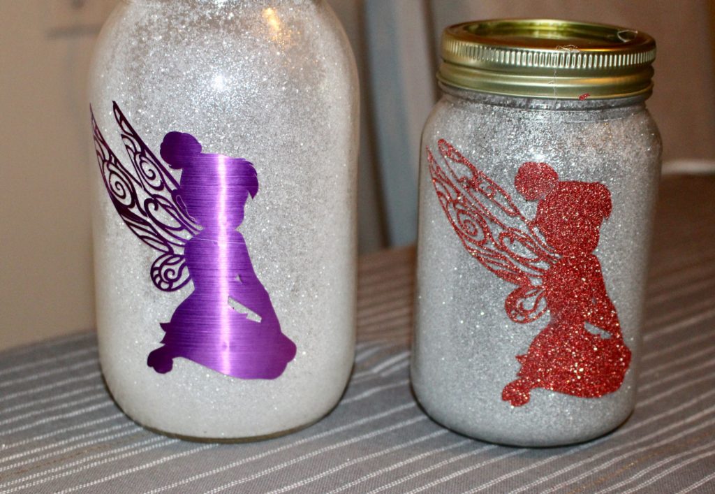 2 mason jars with glitter and tinkerbell