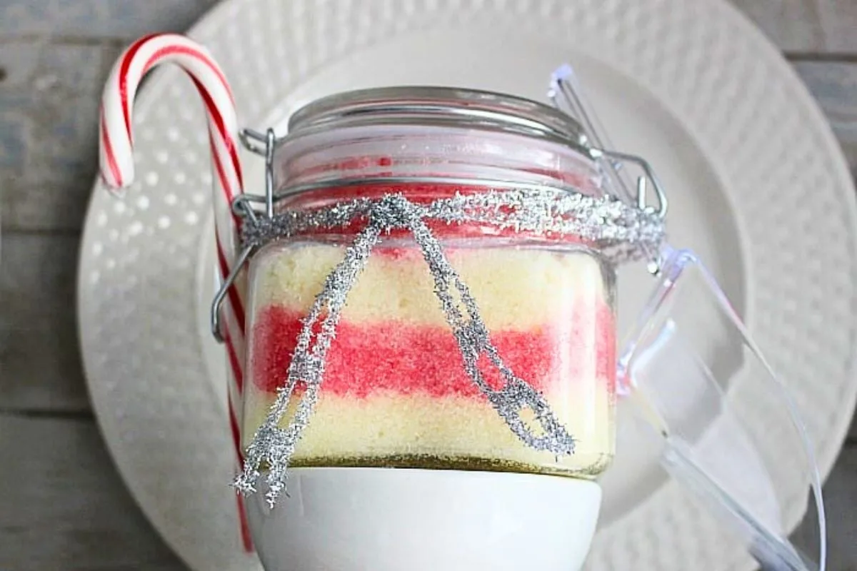 Homemade Peppermint Sugar Scrub in glass jar with candy cane