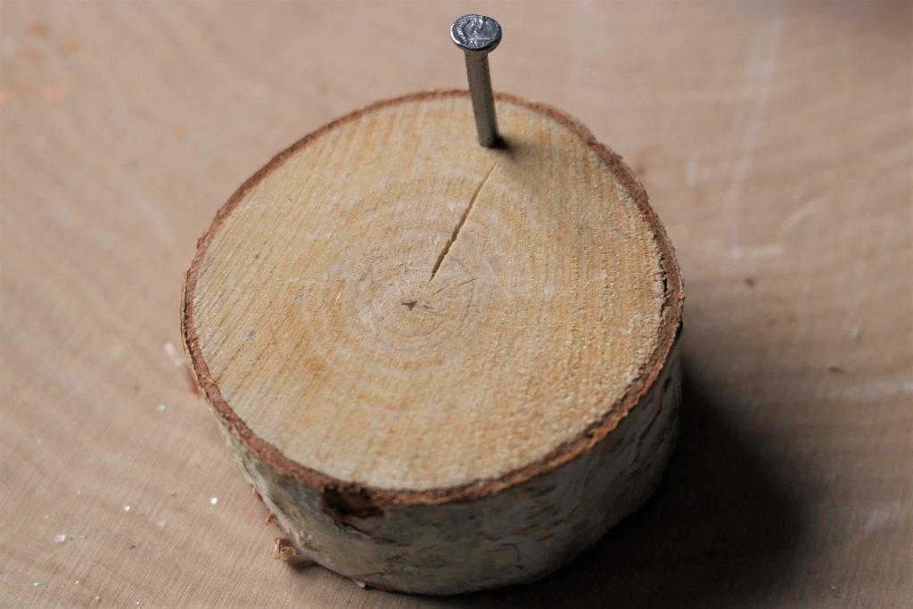 wood slice with nail