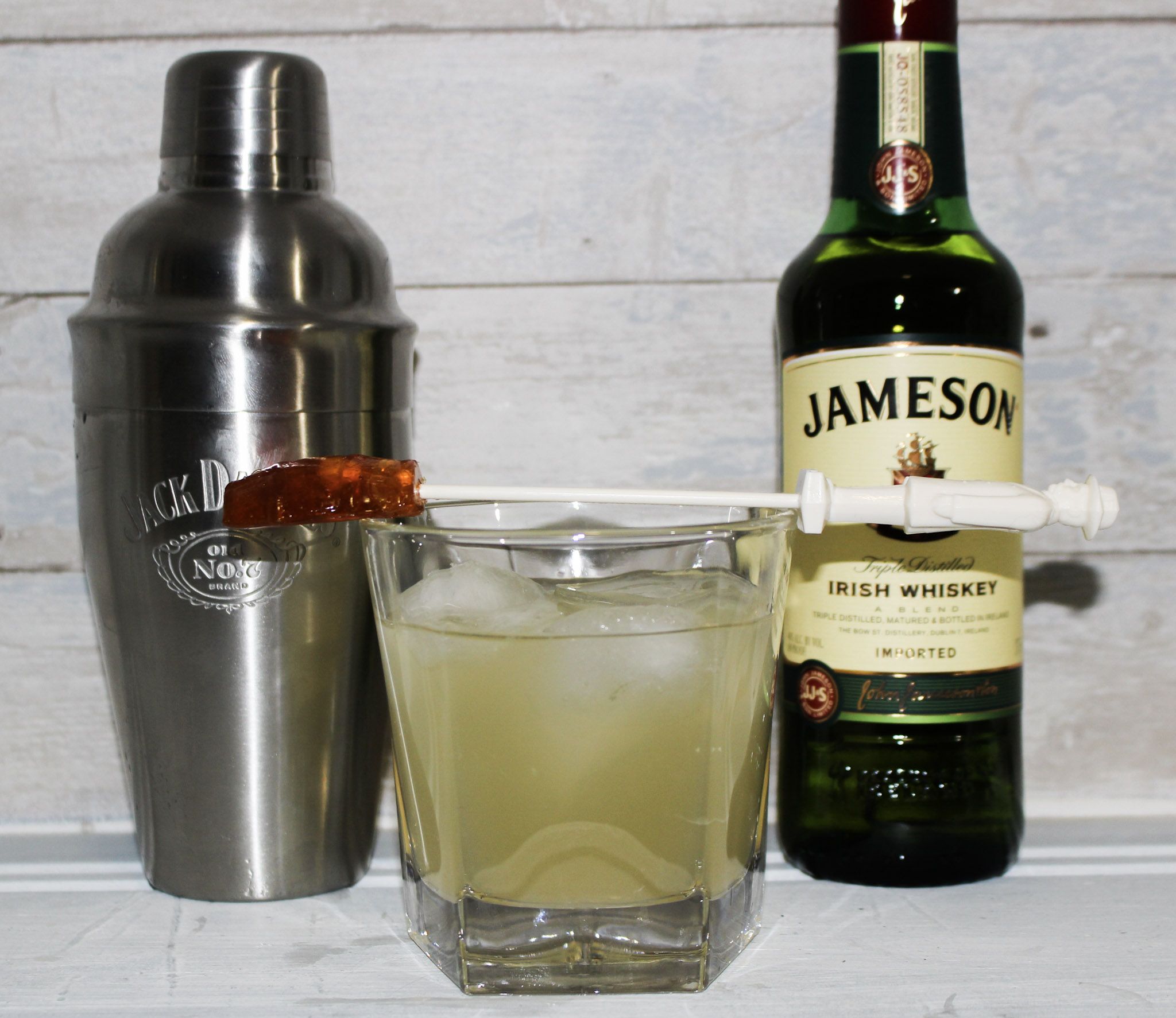 Jameson Irish Whiskey shown with shaker and glass filled with stir stick