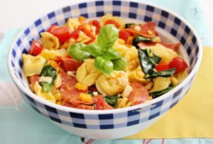 tuscan pasta salad in blue gingham bowl