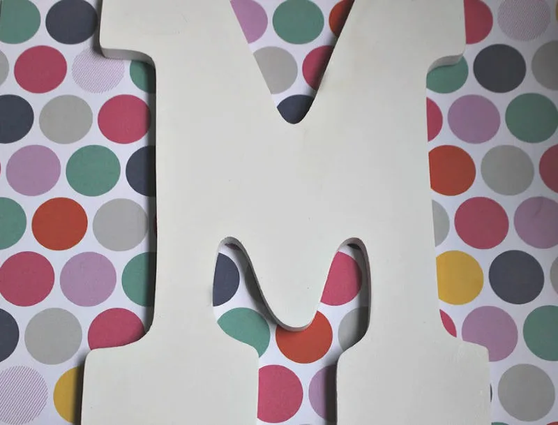 wood letter M on polka dot paper