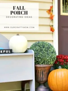 Fall porch decor with gray bench, mums and orange pumpkins