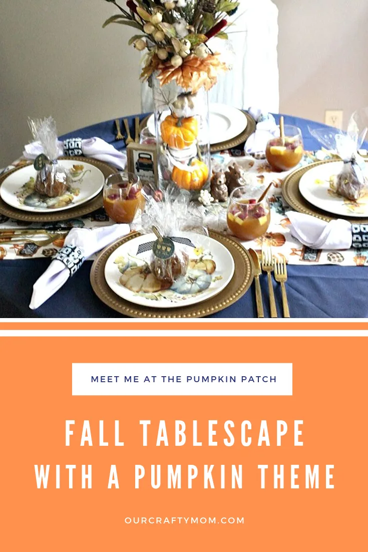 fall tablescape with navy tablecloth and pumpkin dishes