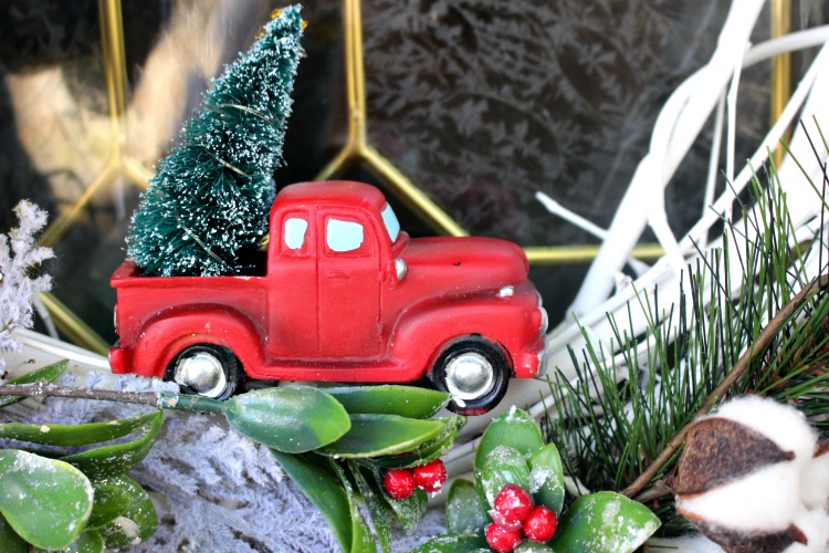 close up of little red truck on wreath