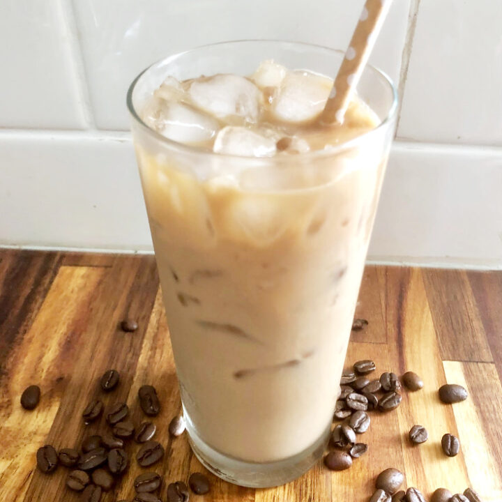 iced coffee on counter with coffee beans