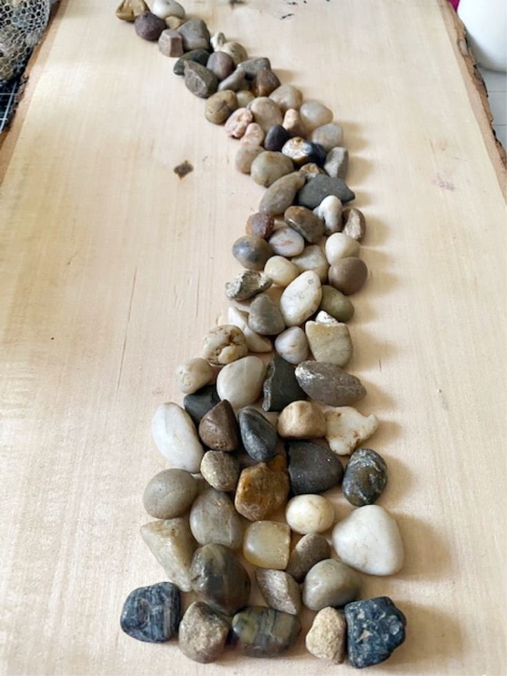 river rocks on wood slab