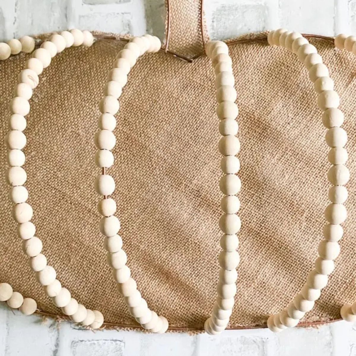 adding burlap to dollar tree pumpkin wire wreath form