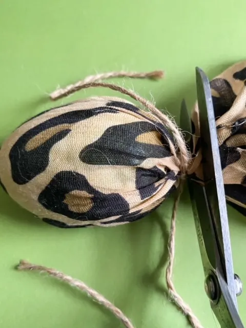 cutting leopard fabric from plastic egg