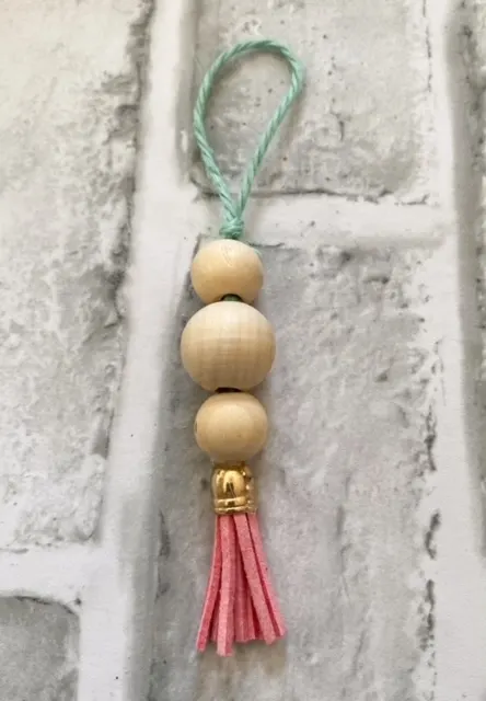 finished wooden bead ornament with tassel