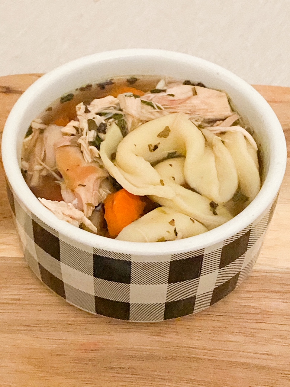 chicken tortellini soup in buffalo check bowl