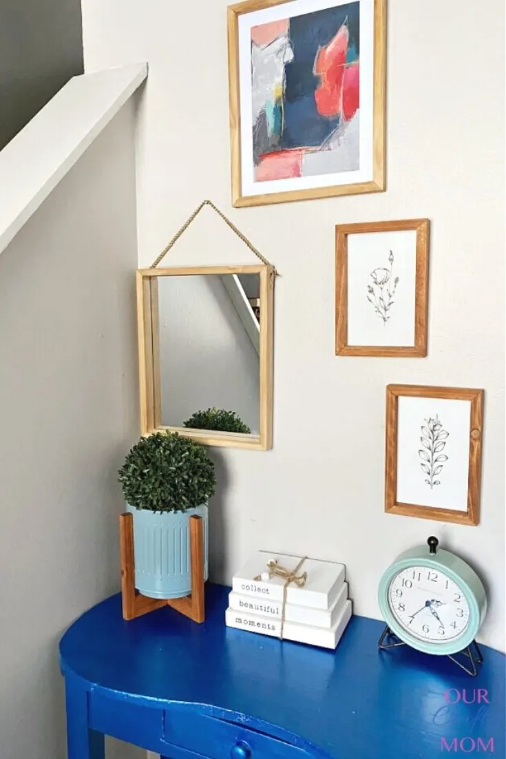gallery wall with blue desk decocrated items
