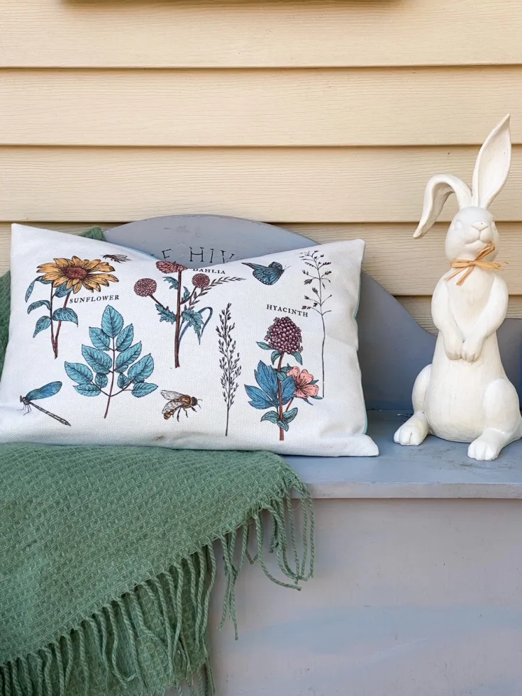 white bunny and spring pillow on front porch