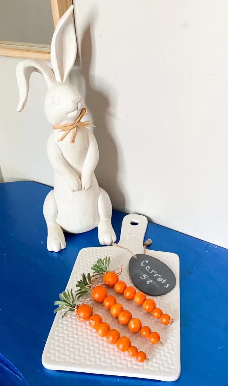 orange painted wood bead carrots on table