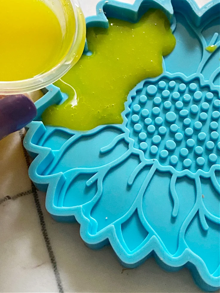 pouring resin into sunflower mold