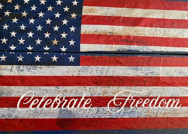 celebrate freedom painted on wood sign