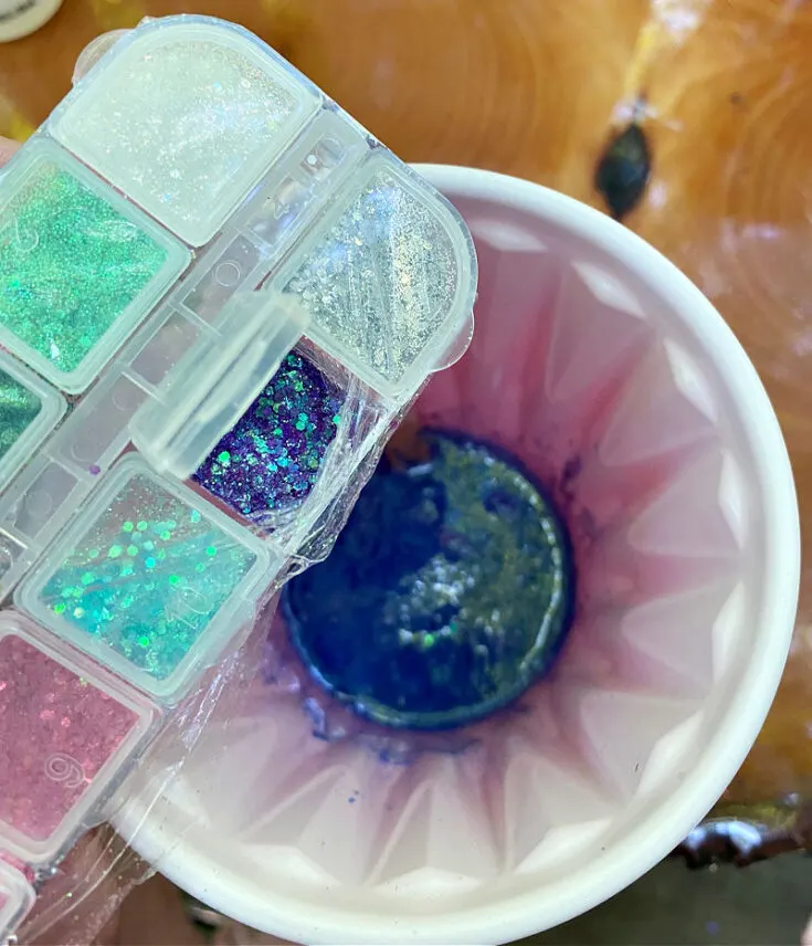 pouring glitter into mixed resin
