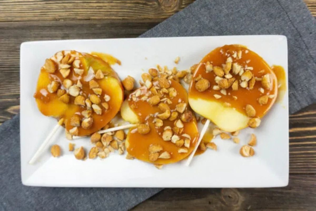 3 sliced caramel apple pops on white dish