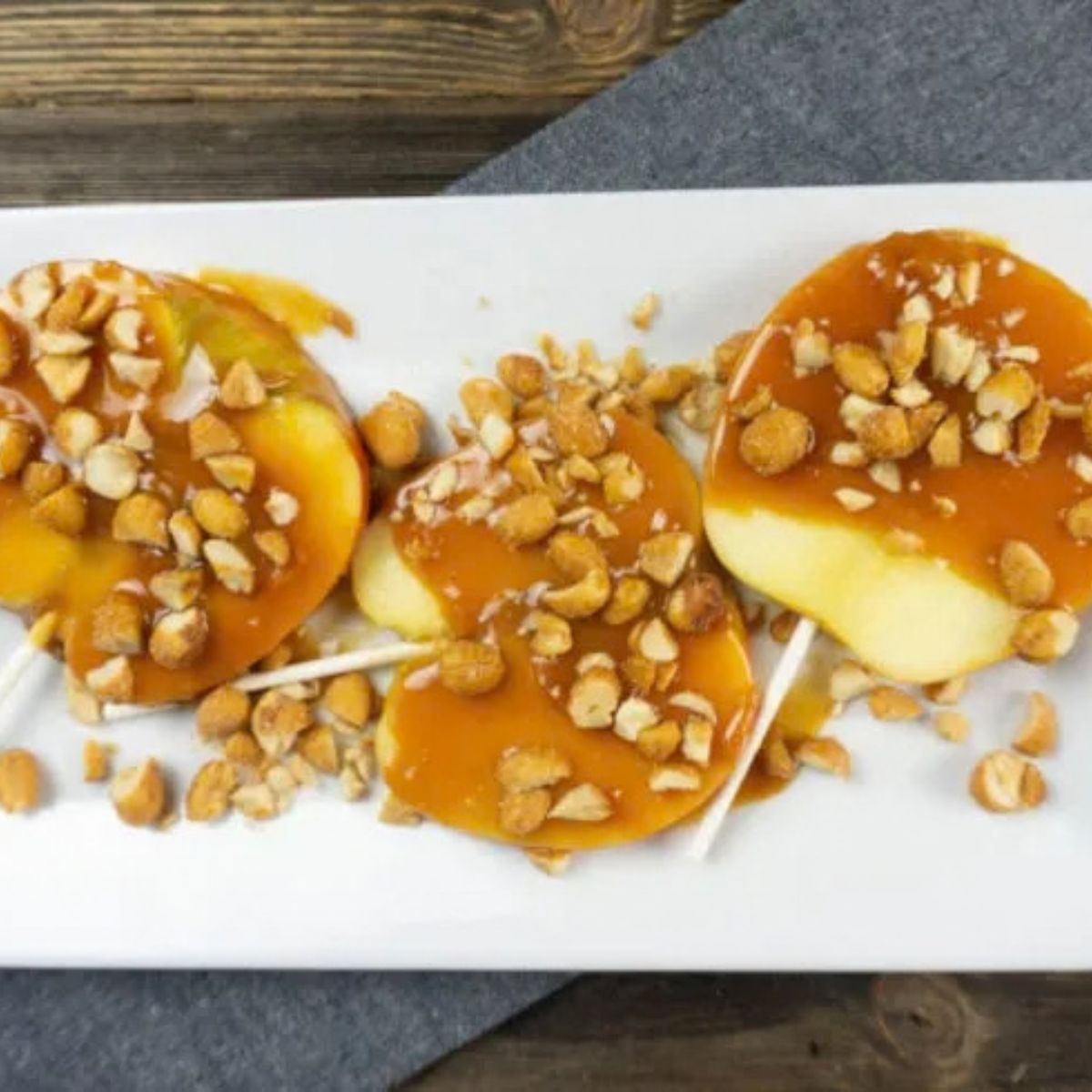 caramel apples sliced on white platter