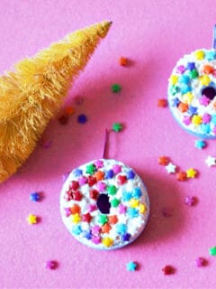 two donuts ornaments on pink backdrop