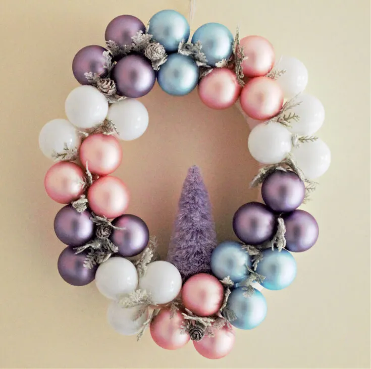 pastel Christmas ornament wreath on wall