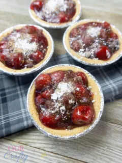 Mini Cherry Crumble Pies on counter