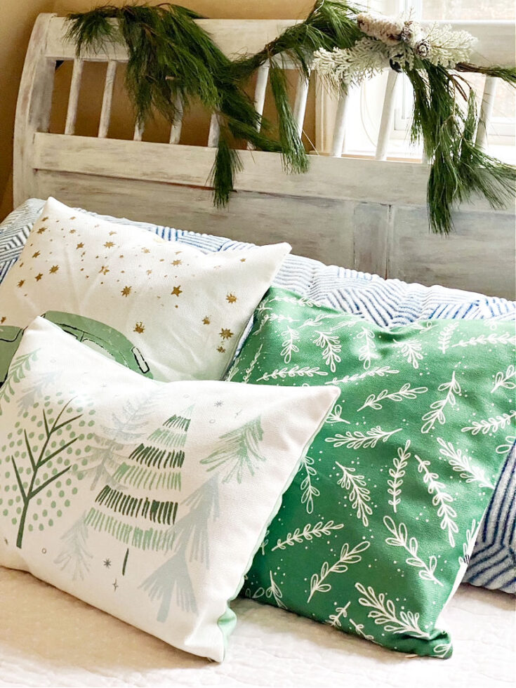 close up of Christmas pillows on bed