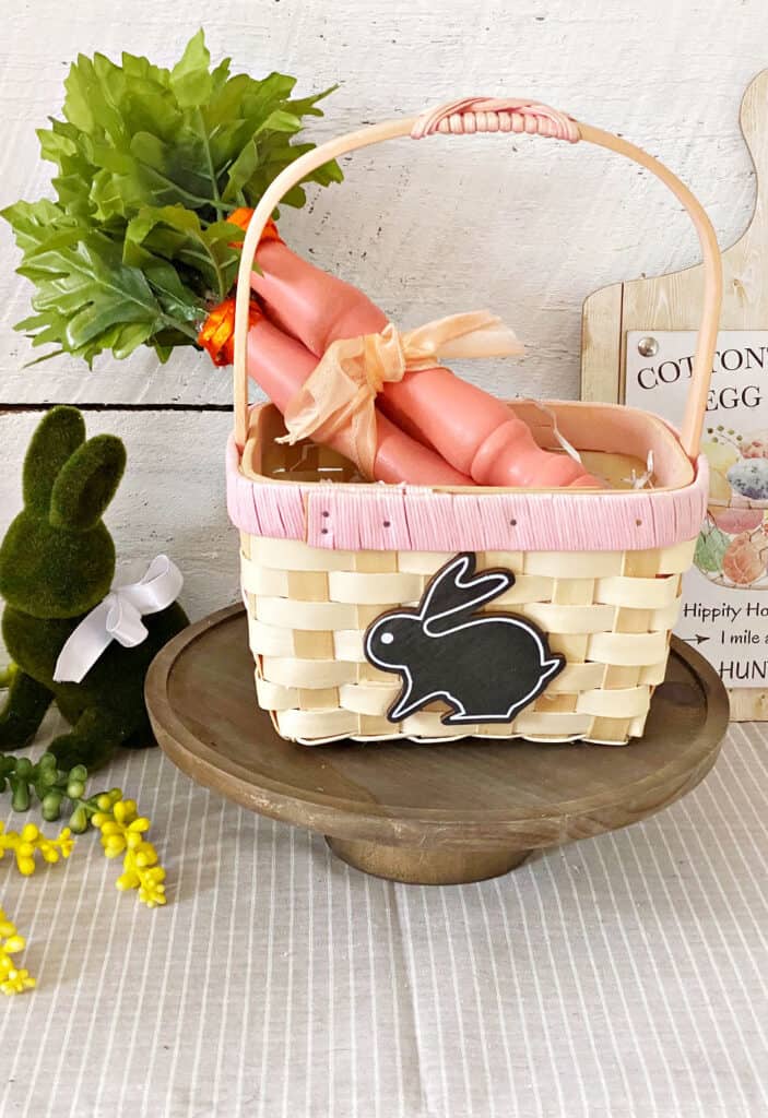 wooden carrots in easter basket with bunny