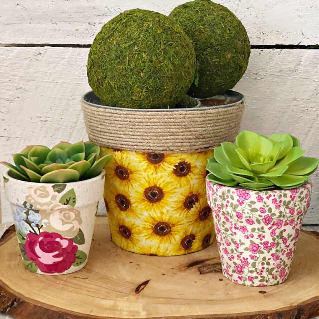 3 fabric covered clay pots on wood tray 