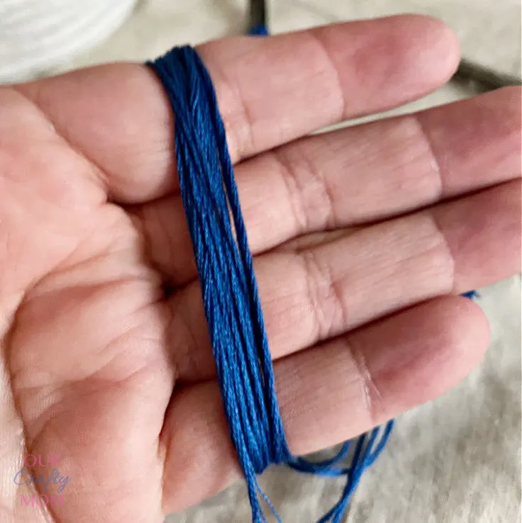 Wrapping thread around hand for tassel