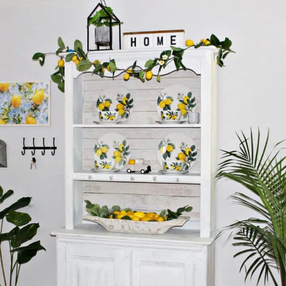 lemon dishes shown on farmhouse hutch