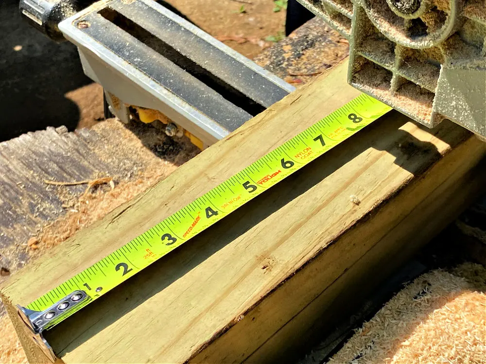 using measuring tape to cut wood