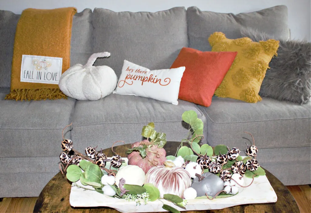 fall living room with dough bowl filled with pumpkins