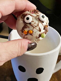 putting hot cocoa bomb in ghost mug
