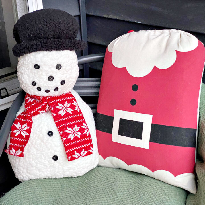 close up of snowman pillow with santa pillow
