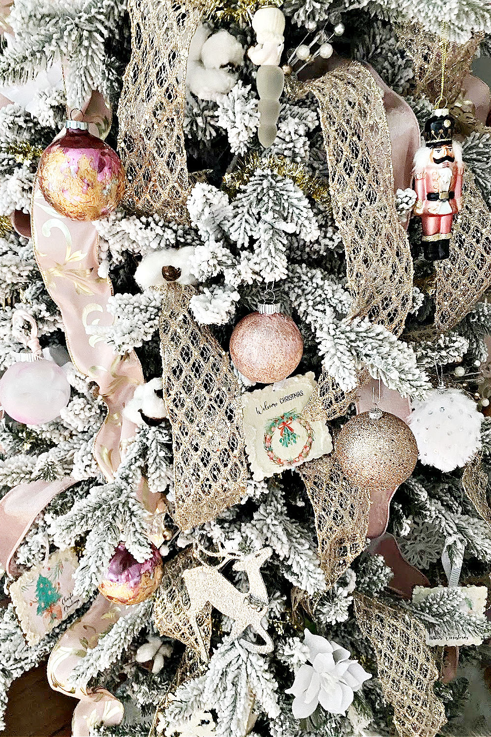 Elegant Pink and Gold Christmas Tree Decorations on a Flocked Tree in living room