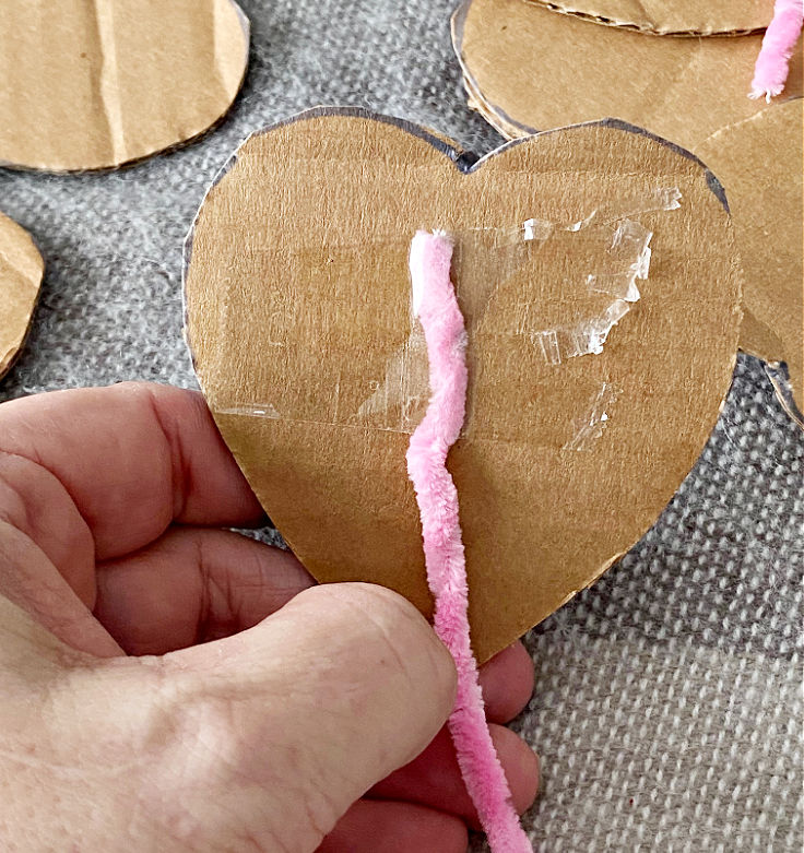 taping yarn to cardboard heart