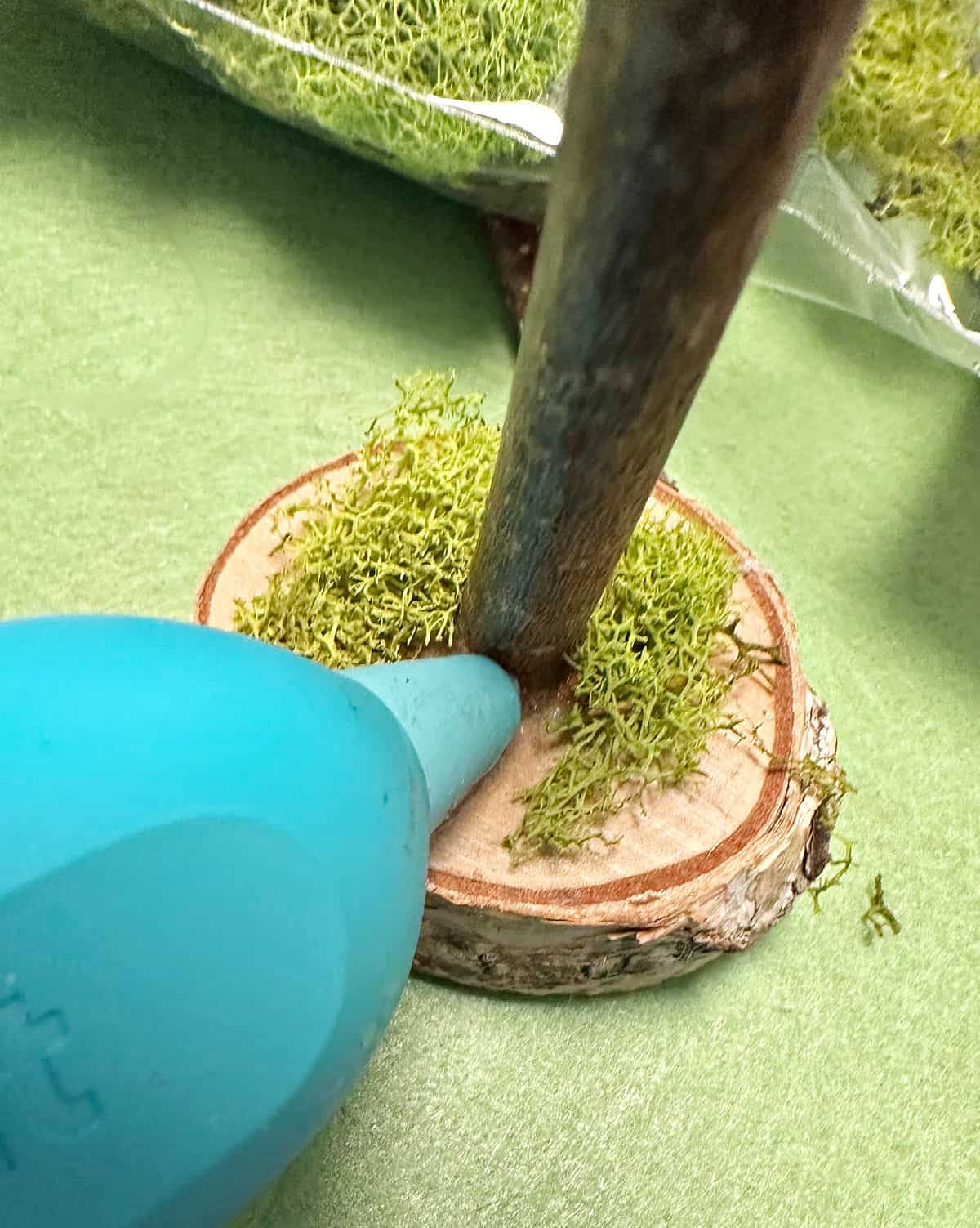 gluing moss to wood piece