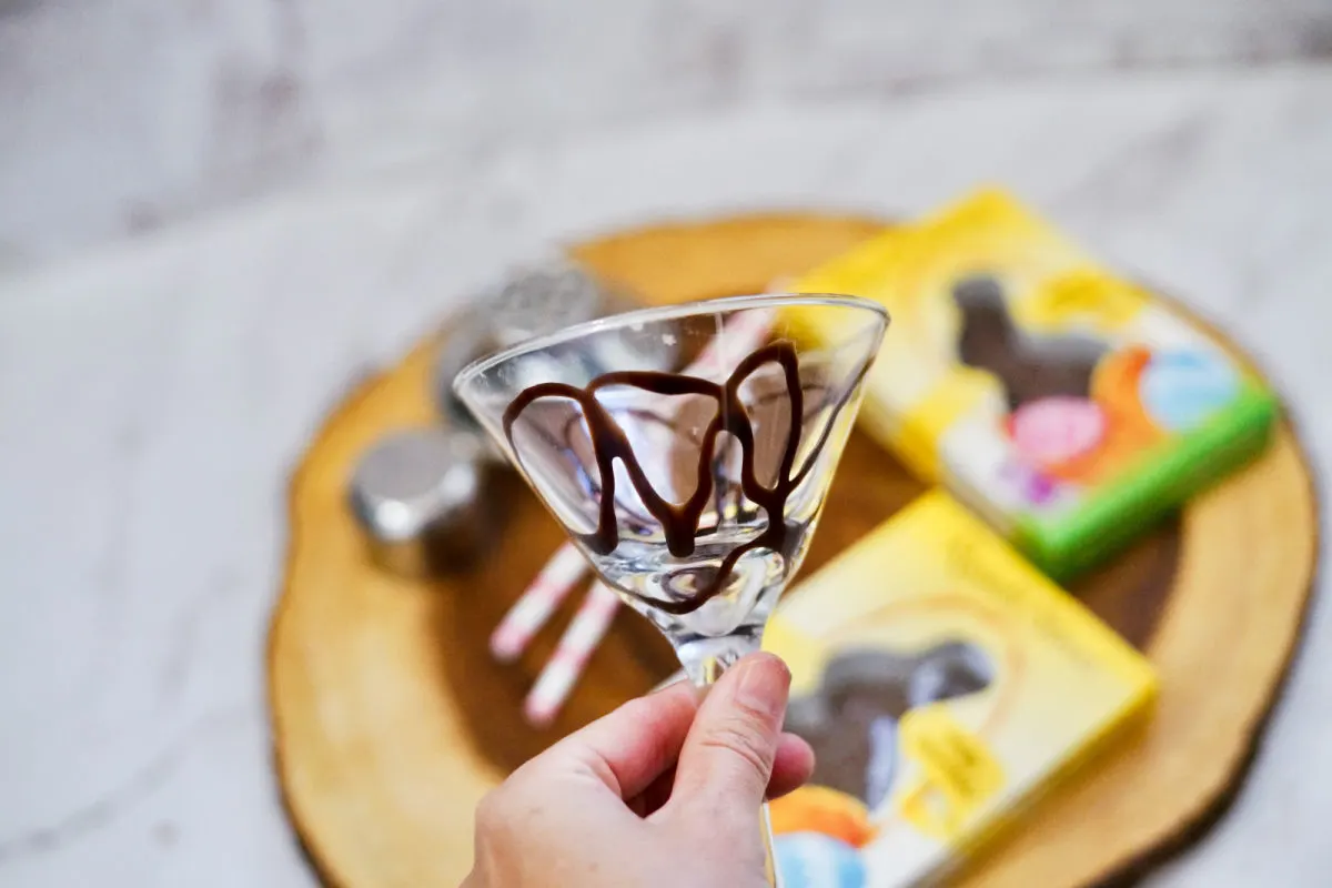 adding chocolate to the martini glass