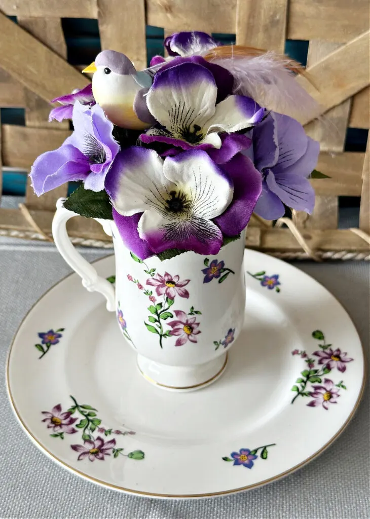 securing flowers into tea cup