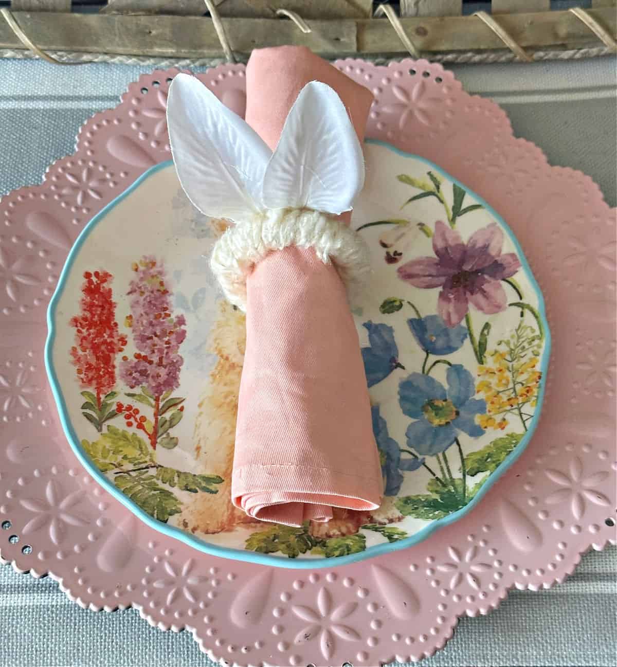 close up of easter napkin ring on pink plate