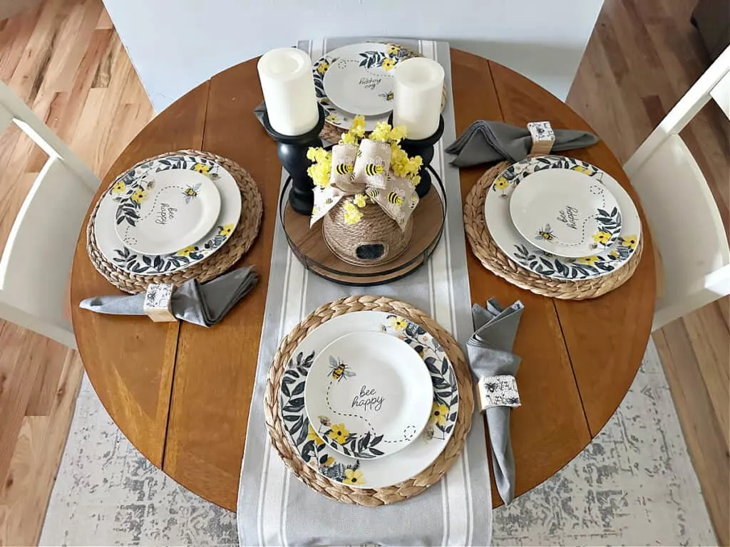 overhead picture of summer tablescape with bee themed dishes