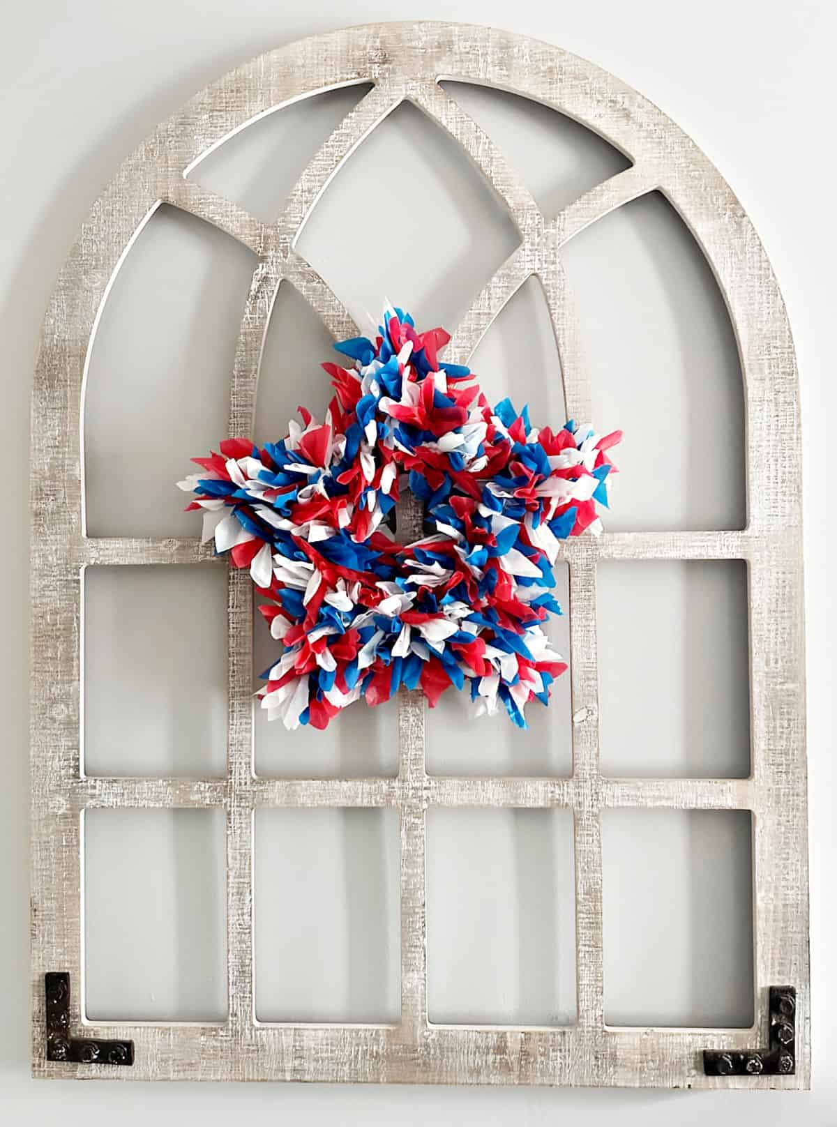 patriotic red white and blue wreath on arch