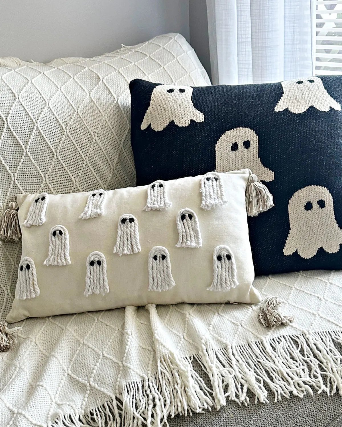 pair of halloween throw pillows on sofa