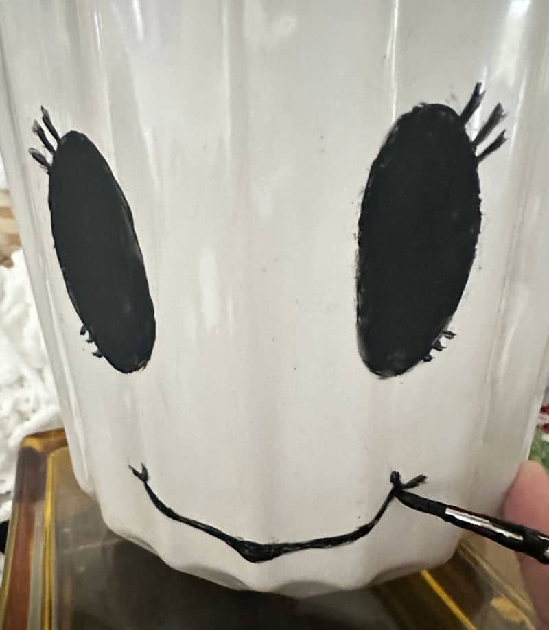 ghost face on vase