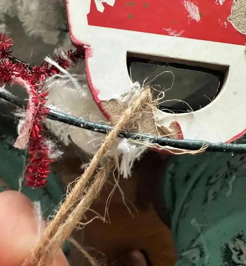 tying twine to wreath