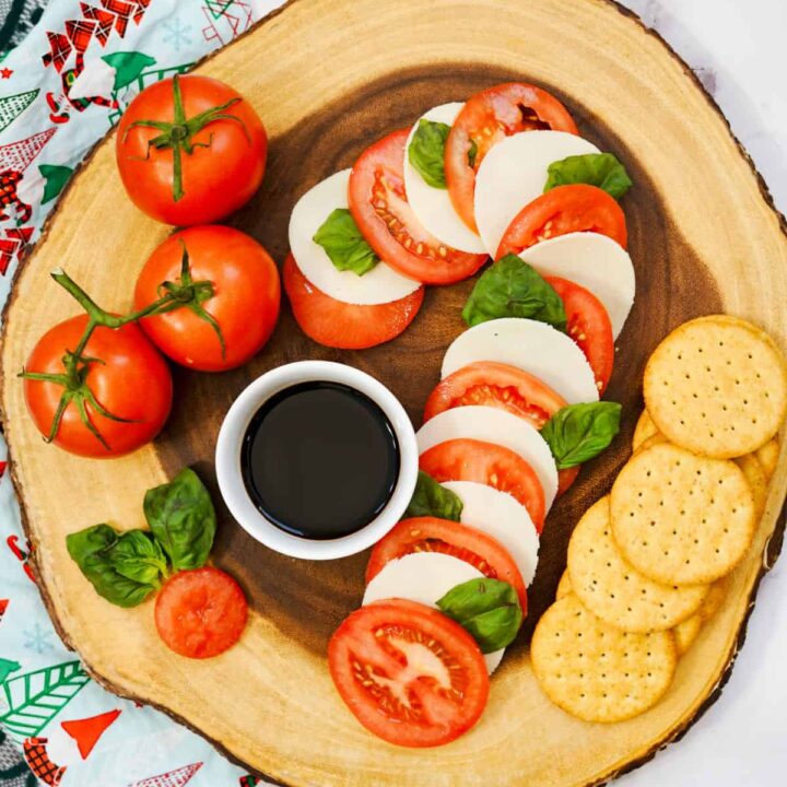caprese candy cane board on wood serving platter