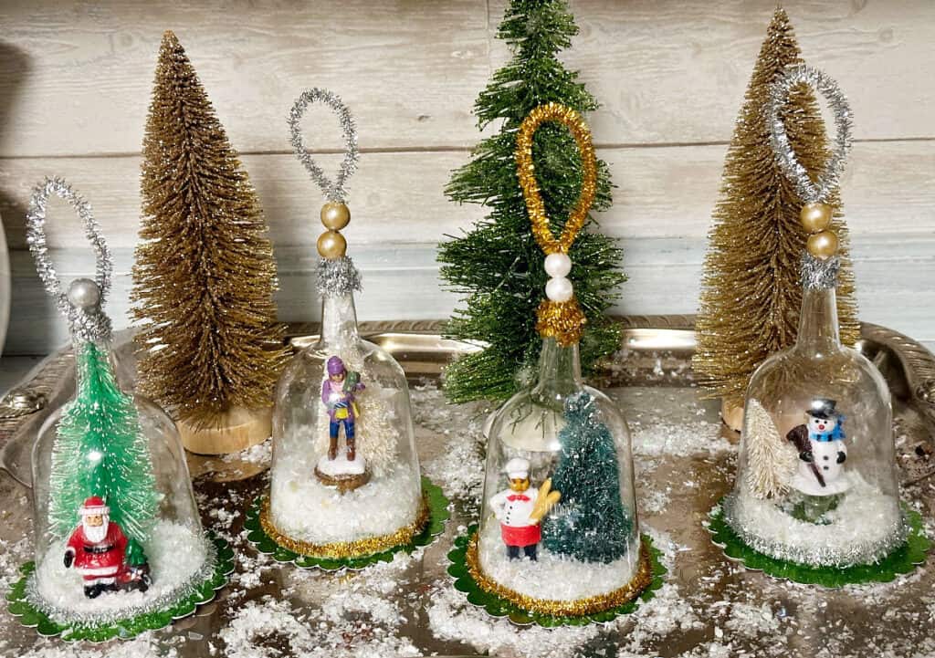 4 snow globes on tray