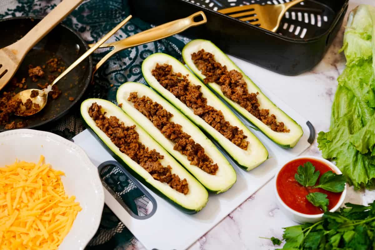 filling zucchinis with taco meat