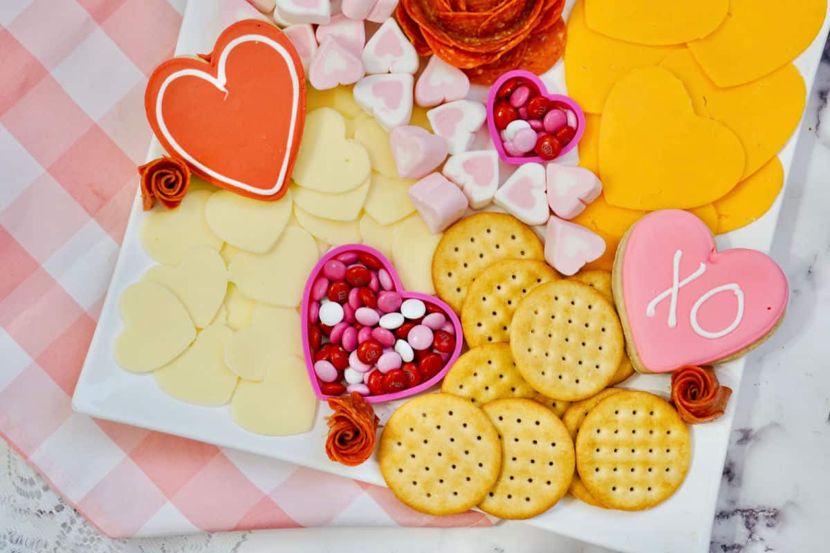 arranging sweet treats on valentine board